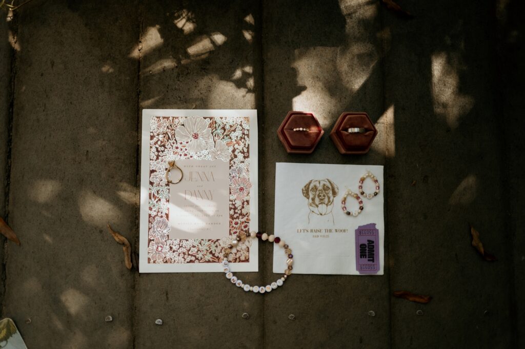 Wedding detail flat lay with friendship bracelet table settings at McGill Rose Garden Charlotte NC photographed by Bekah Cabrejos Photography