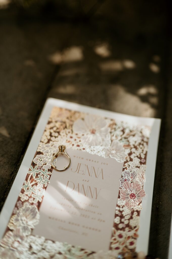 Wedding detail flat lay with friendship bracelet table settings at McGill Rose Garden Charlotte NC photographed by Bekah Cabrejos Photography
