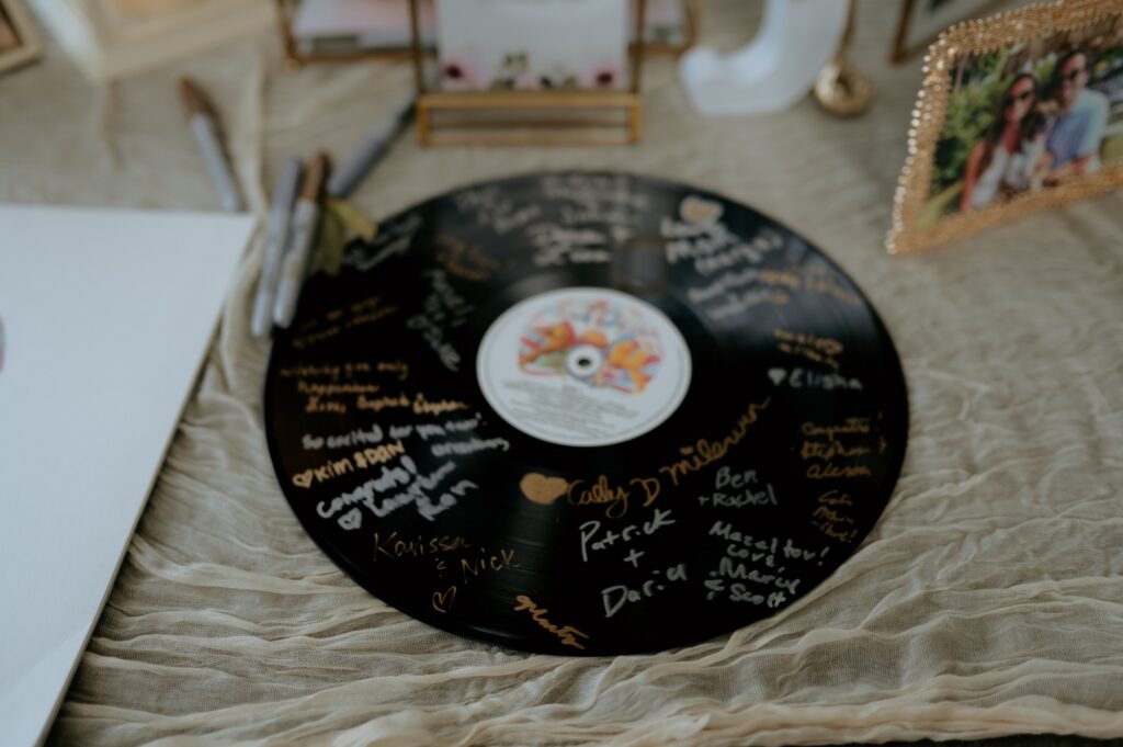 Wedding detail flat lay with friendship bracelet table settings at McGill Rose Garden Charlotte NC photographed by Bekah Cabrejos Photography